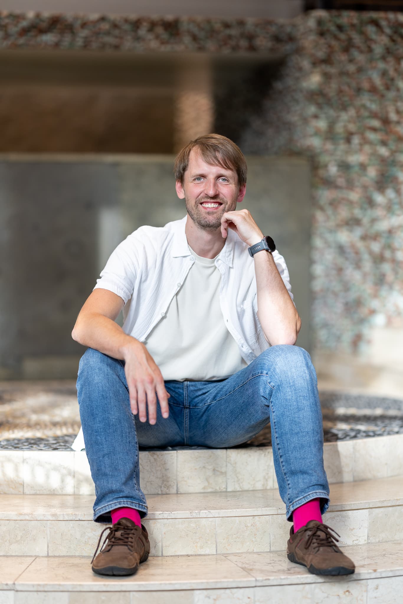 Rytis seated in a bright studio
